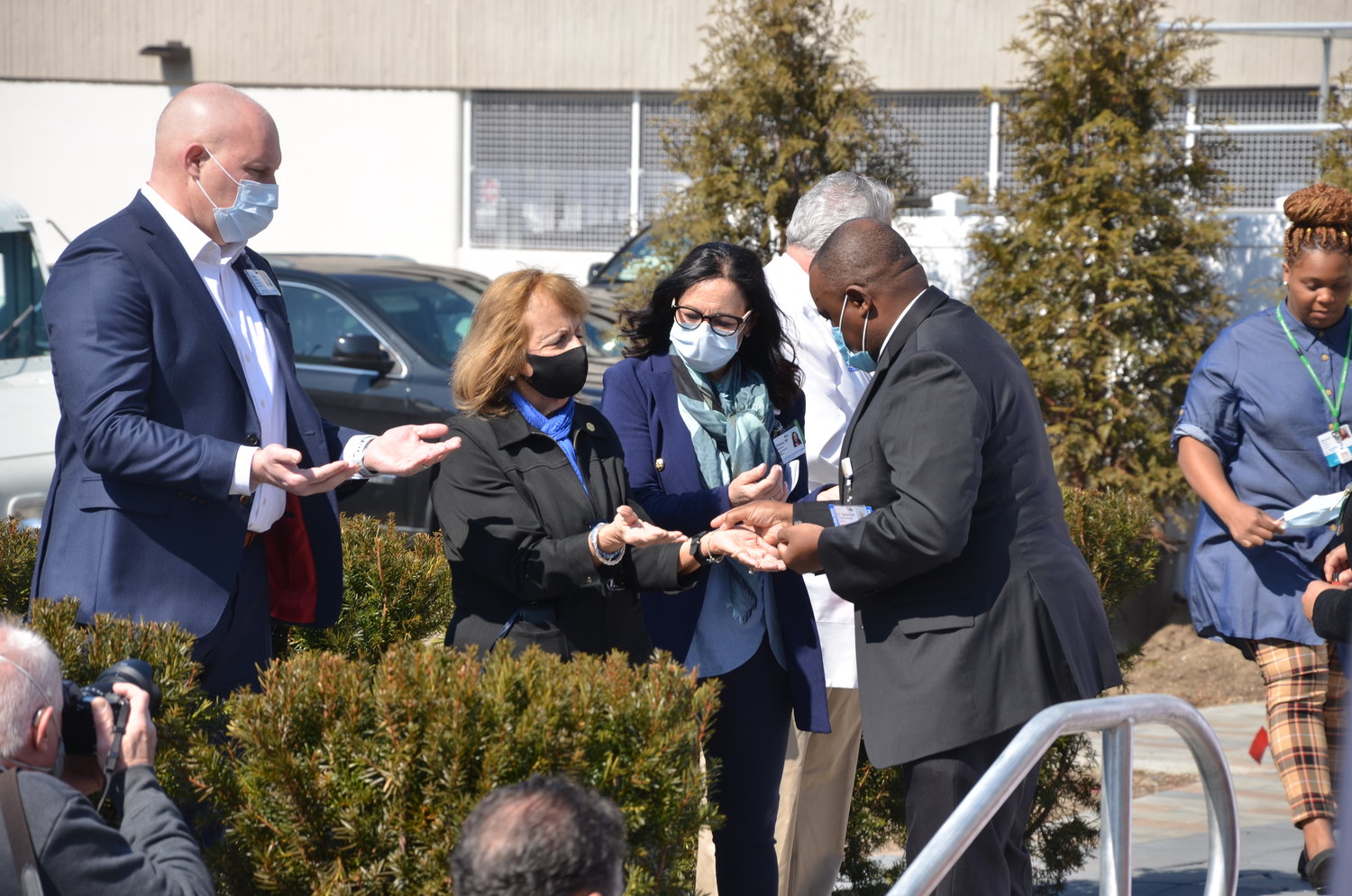 Islip Town supervisor Angie Carpenter receives a blessing of the hands from the Reverend Father Sylvester Chukwumalume at the remembrance ceremony on Thursday, March 11.